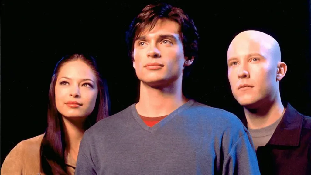 The best superhero TV shows: The Smallville cast stand against a black background looking forward